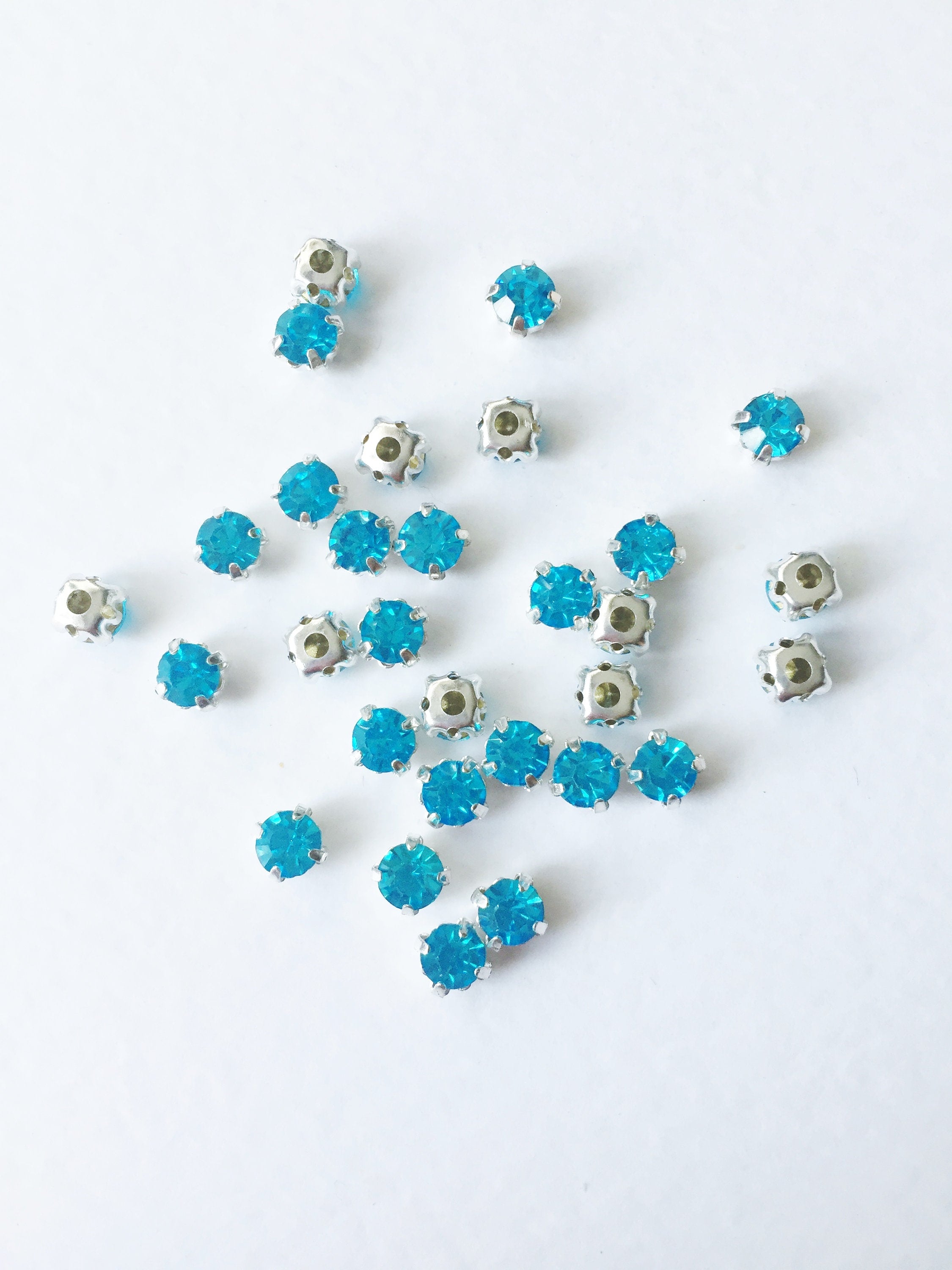 48 x Aquamarine Glass Rhinestones in Silver Sew-on Setting, 4mm or 5mm
