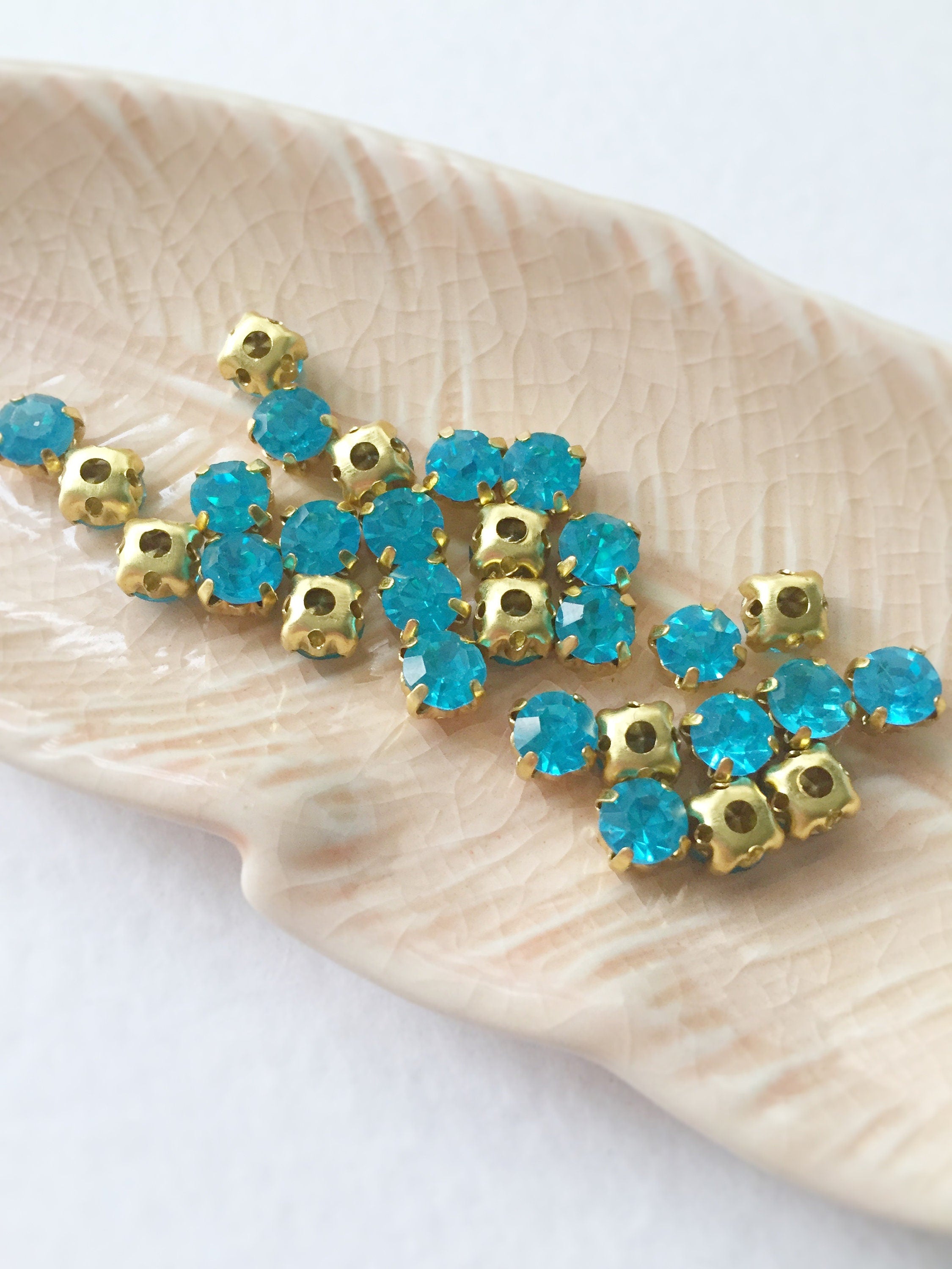 48 x Aquamarine Glass Rhinestones in Gold Sew-on Setting, 4mm or 5mm