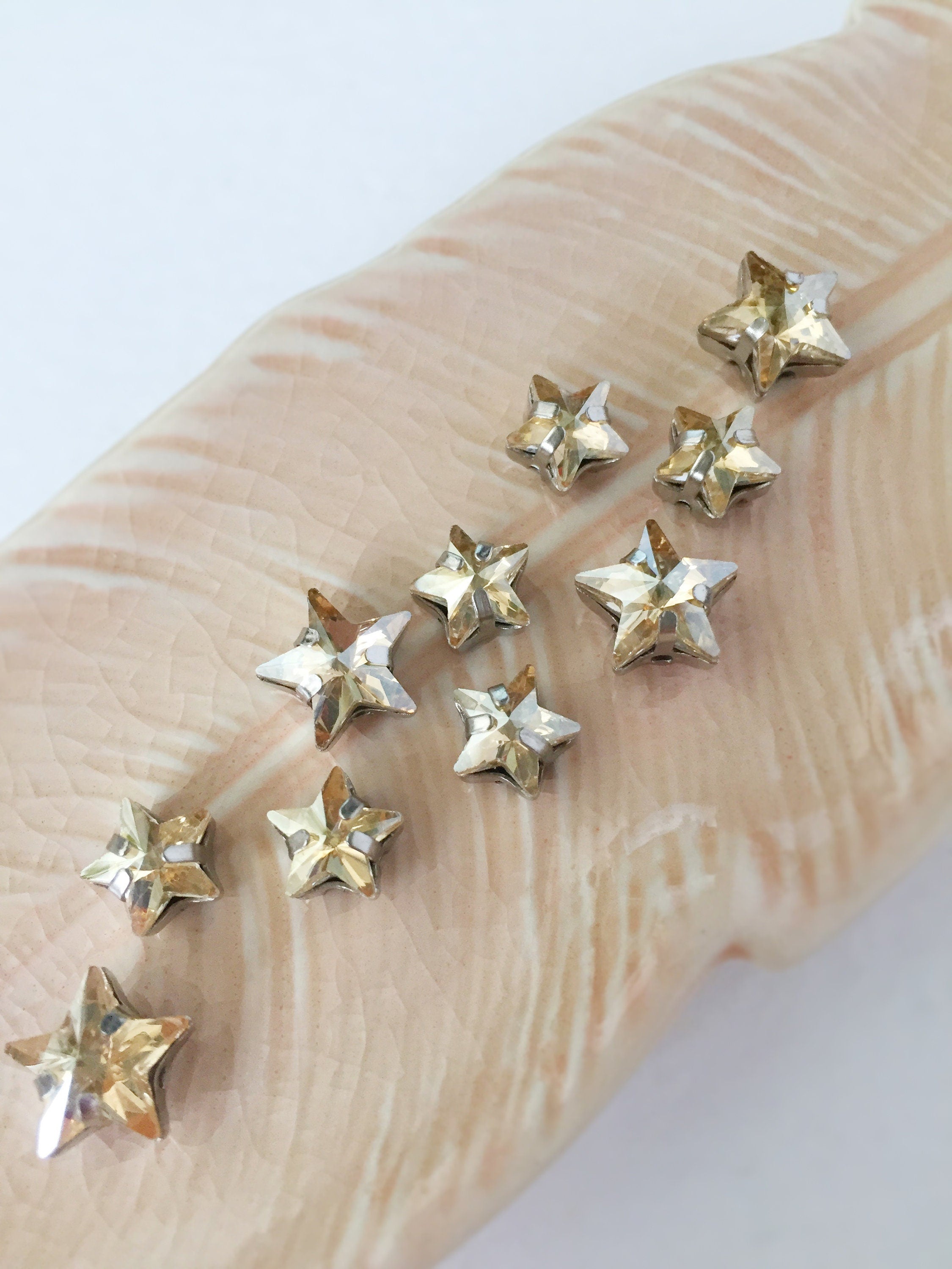 12 x 10mm Golden Shadow Crystal Star Rhinestones, Sew-on Rhodium Base (0309)